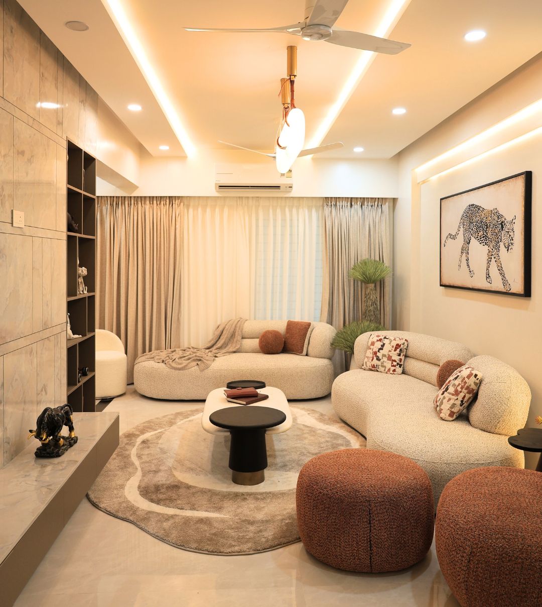 Living room with a curved sofa and warm ceiling light